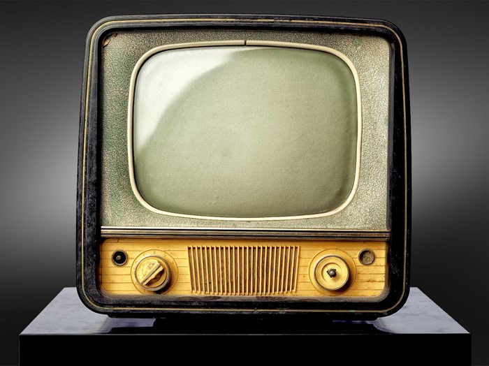 Vintage television set with knobs and speaker grille