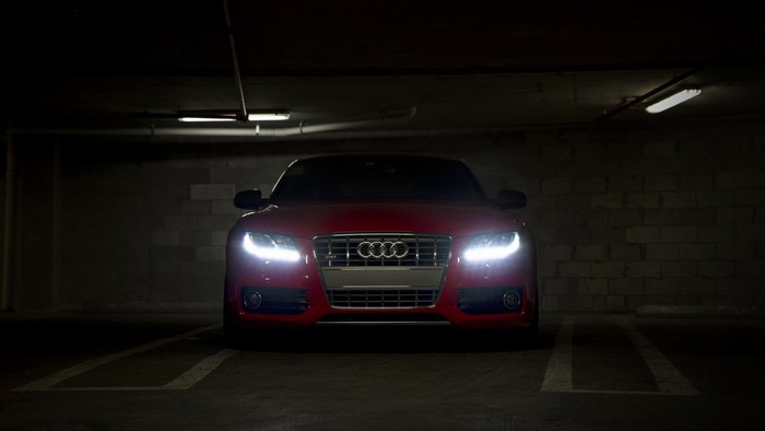 Red Audi S5 parked in a dark garage