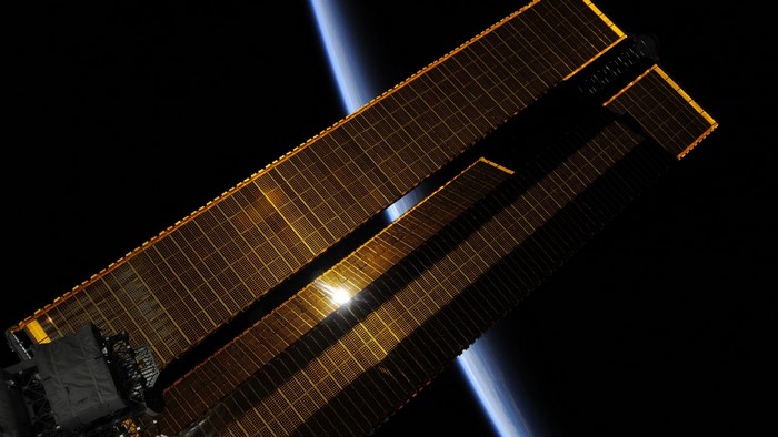 International Space Station solar arrays with Earth in background
