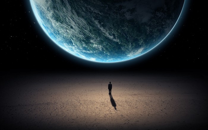 Man standing on a barren planet looking at Earth