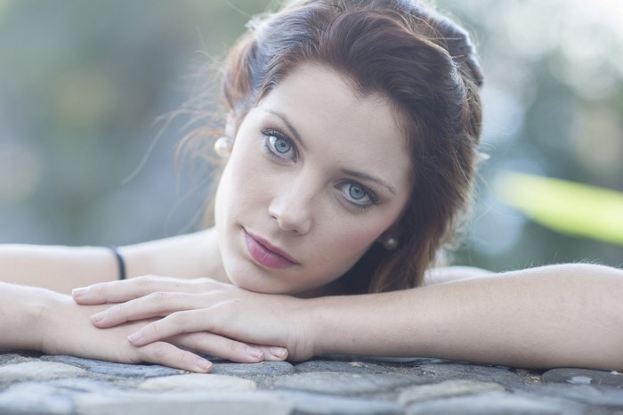 Woman with blue eyes and brown hair posing