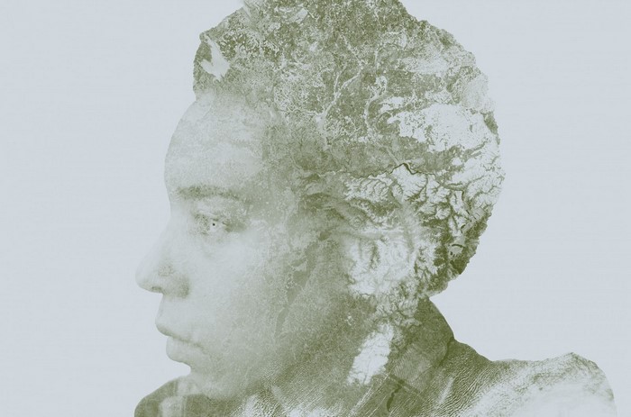 Double exposure portrait of a woman with a landscape
