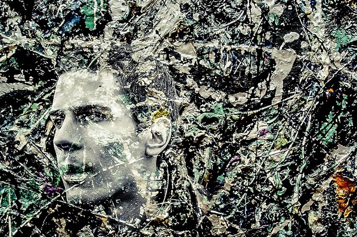 Man's face superimposed on abstract painting