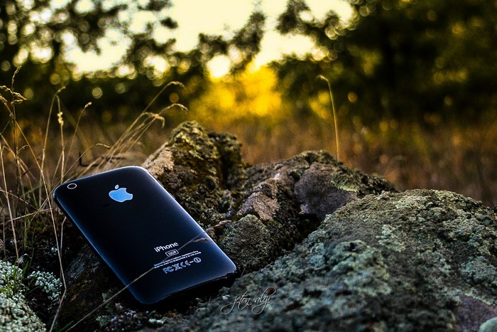Black iPhone on rocks in nature