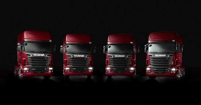 Four red Scania trucks lined up