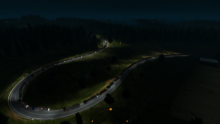 Trucks on a winding road at night in Euro Truck Simulator 2