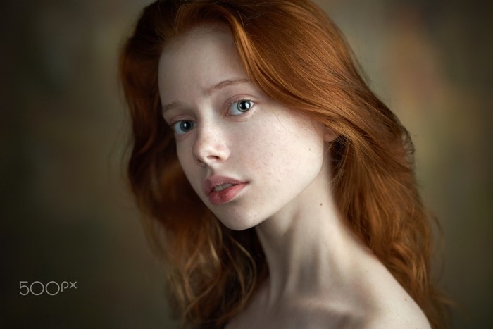 Portrait of a young redhead woman with blue eyes