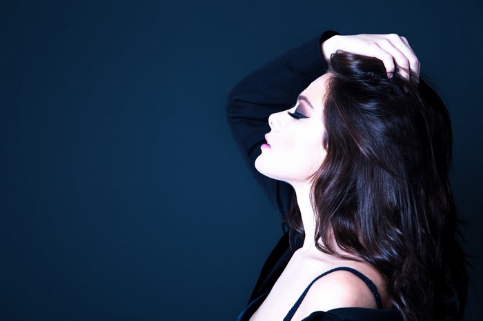 Woman with hand in hair, profile view