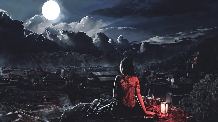 Woman with back tattoo overlooking a city at night