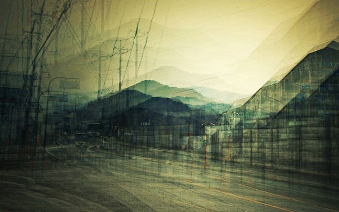 Double exposure of a street with mountains and power lines
