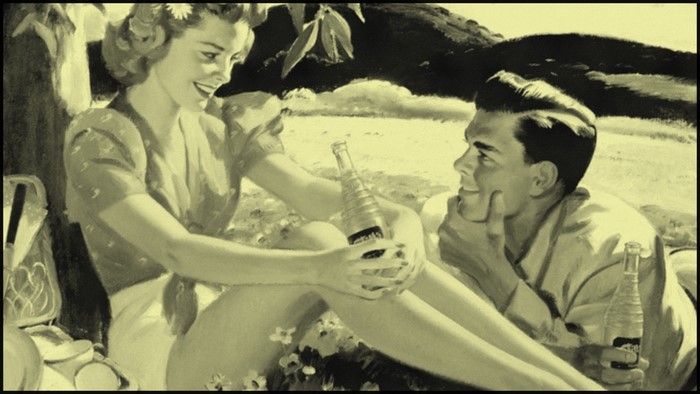Couple having a picnic with soda bottles