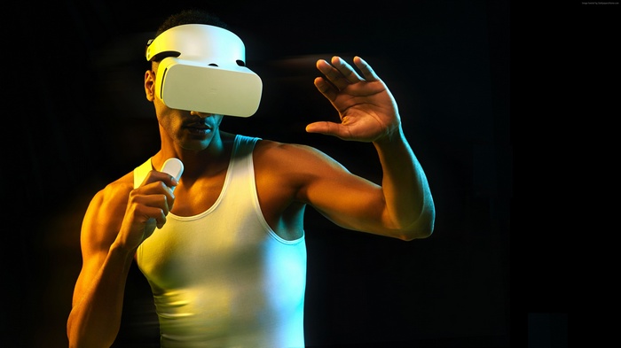 Man wearing VR headset holding controller