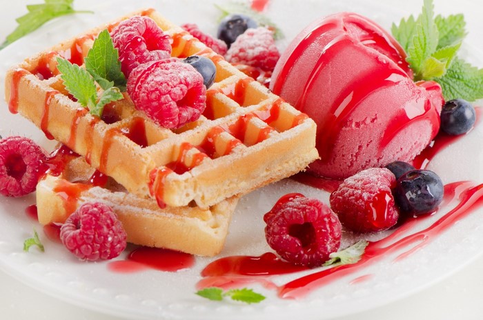 Waffles with ice cream, raspberries, and blueberries