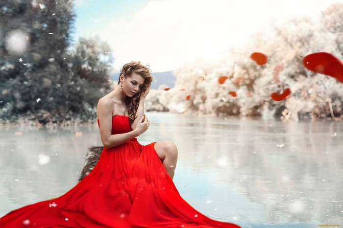Woman in red dress by the water