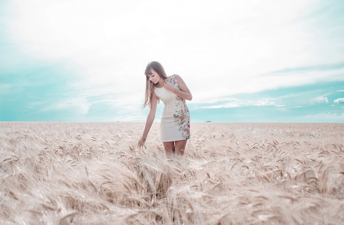 Woman in a floral dress in a wheat field