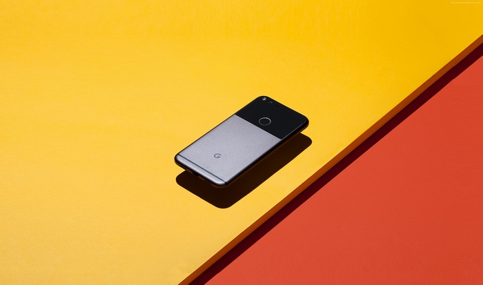 Google Pixel smartphone on yellow and orange background