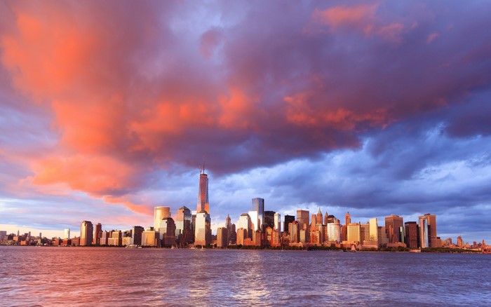 New York City skyline at sunset over the water