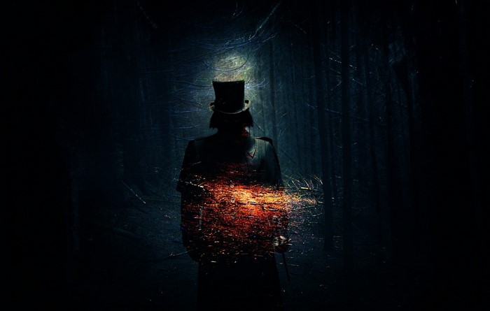 Man in top hat in dark forest with glowing effect