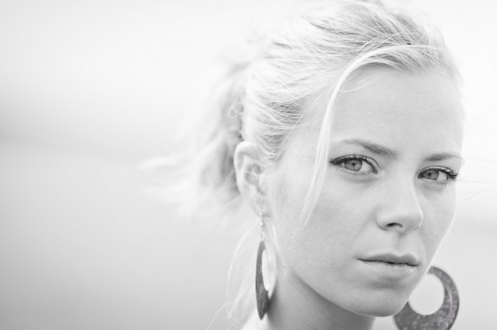 Monochrome portrait of a woman with blonde hair and large earrings