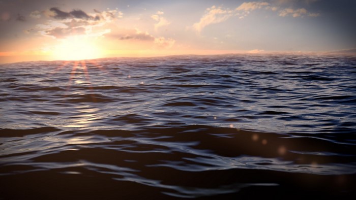 Sunset over the ocean with waves