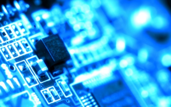 Close-up of a blue illuminated circuit board with microchips