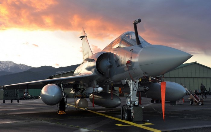 Mirage 2000 fighter jet on tarmac at sunset