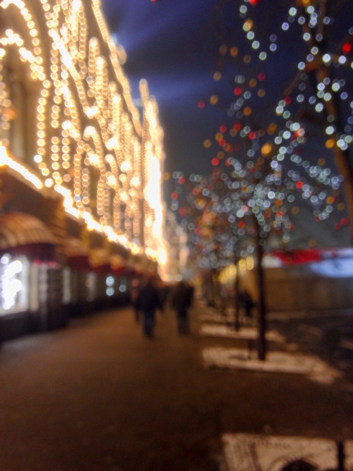 Street decorated with Christmas lights at night