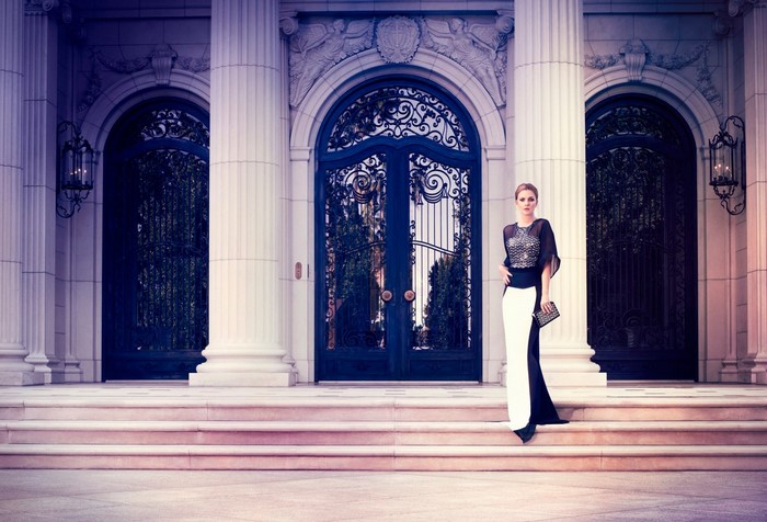 Woman in a black and white dress standing on steps