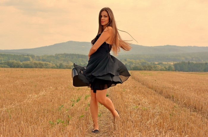 Woman in black dress in a field