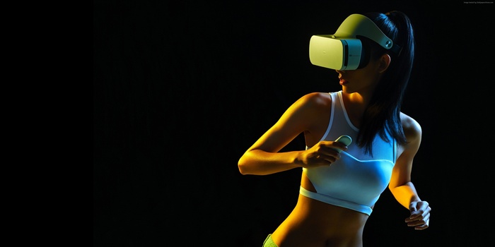 Woman wearing VR headset and holding controllers