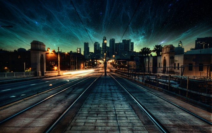 Cityscape at night with nebula sky and tram tracks