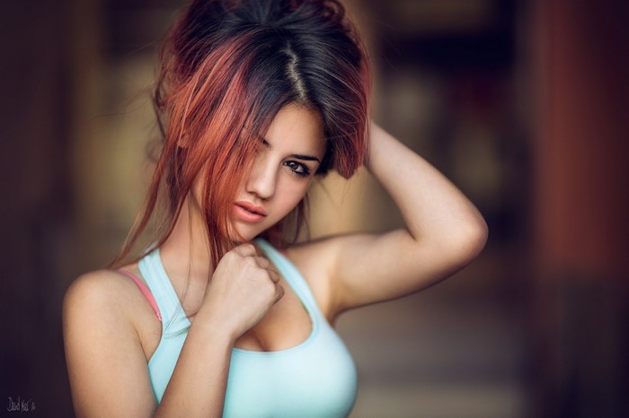 Woman with red-streaked hair in a tank top
