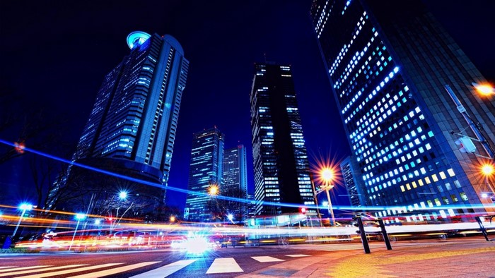 Cityscape at night with light trails from traffic
