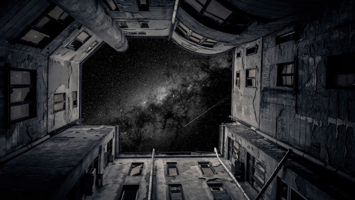 Worm's eye view of old buildings against the Milky Way