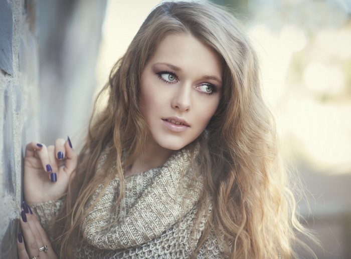 Woman with long blonde hair wearing a sweater