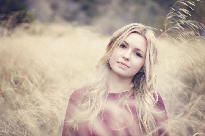 Young woman with blonde hair in a field