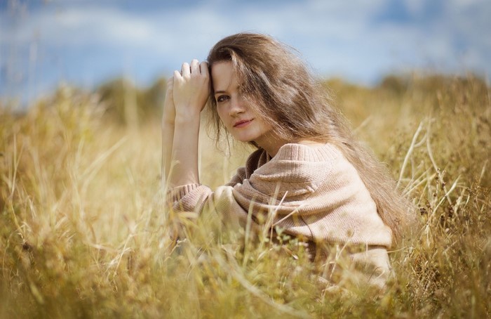 Woman sitting in a grassy field