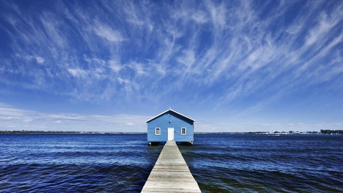 Blue boathouse on a pier over the water