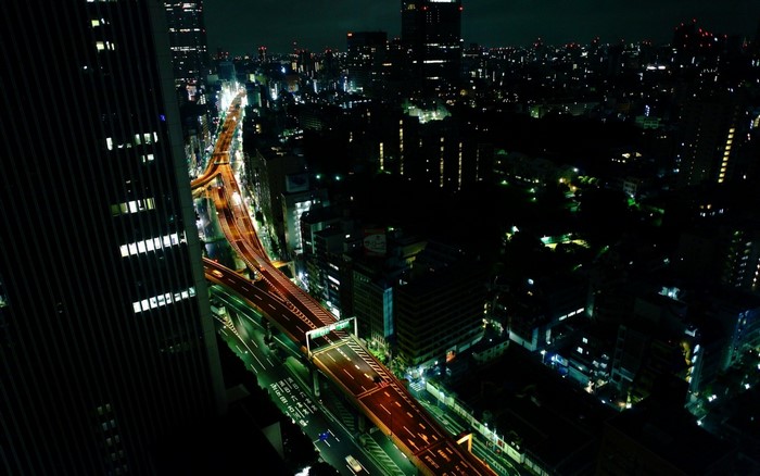 Nighttime aerial view of Tokyo highway and cityscape