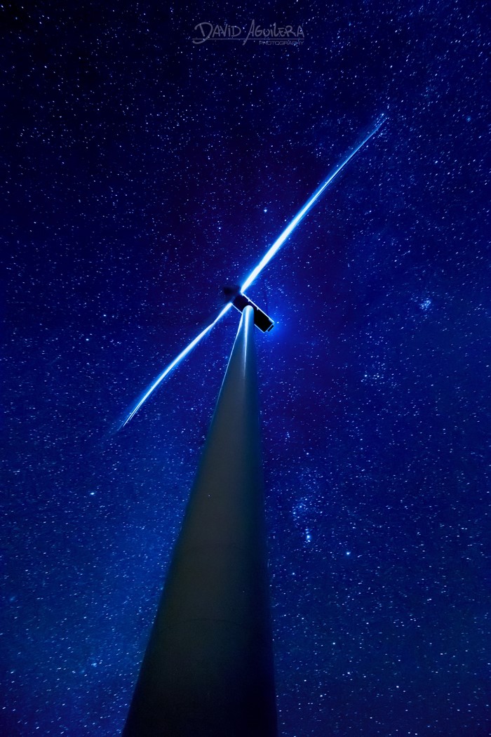 Wind turbine against a starry night sky