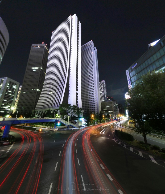Nighttime cityscape with skyscrapers and light trails in Japan