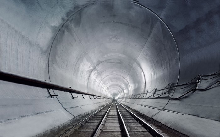 Monochrome photography of a symmetrical railway tunnel