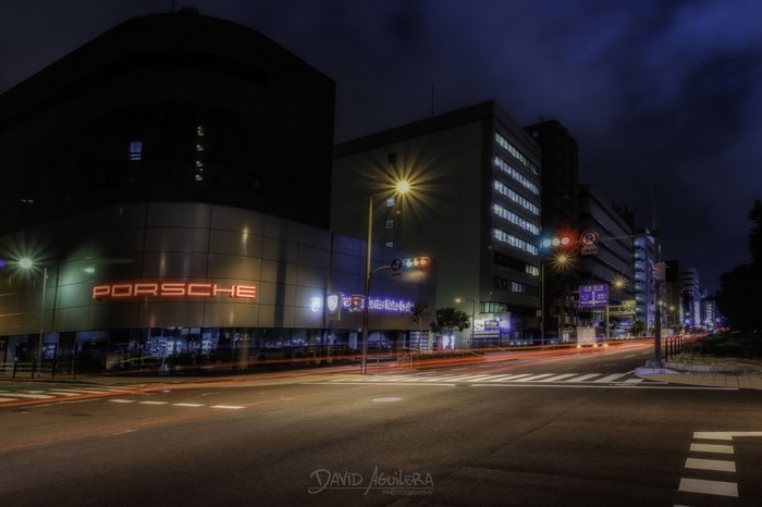Porsche dealership in a Japanese city at night