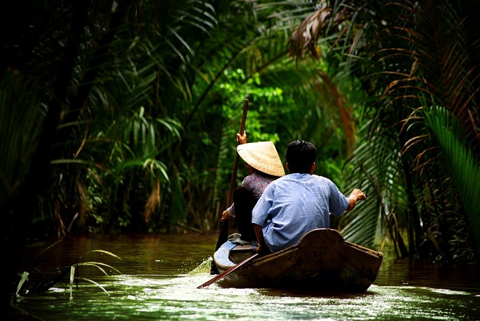 Two people in a boat on a jungle river