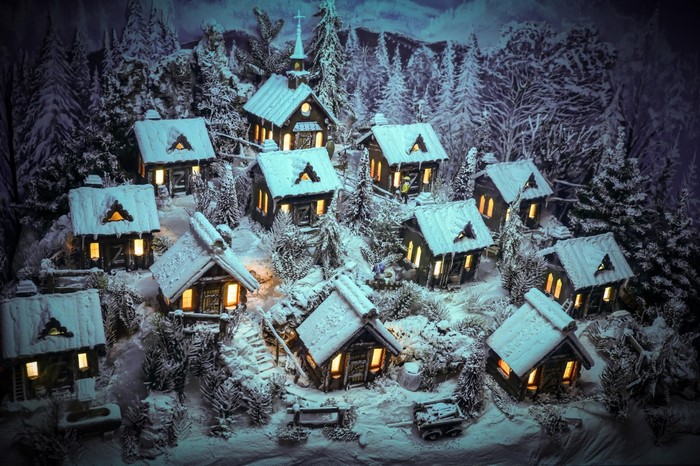 Miniature winter village with snow-covered houses and trees