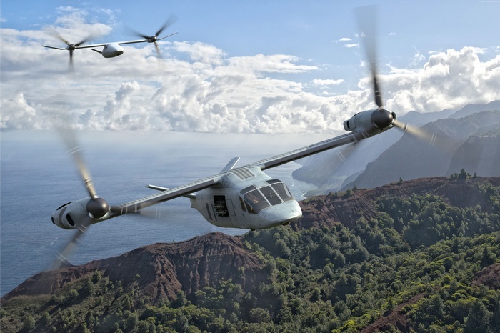 Bell V-247 Vigilant tiltrotor aircraft flying over mountains