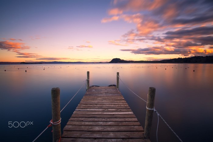 Wooden pier on a lake at sunset