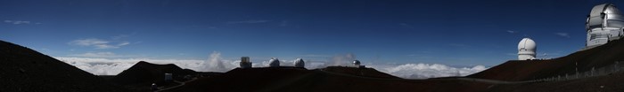 Panoramic view of Mauna Kea Observatories above clouds