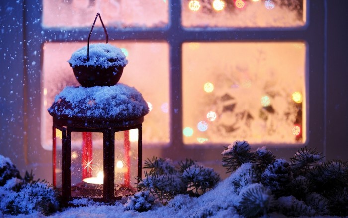 Christmas lantern with snow and bokeh lights