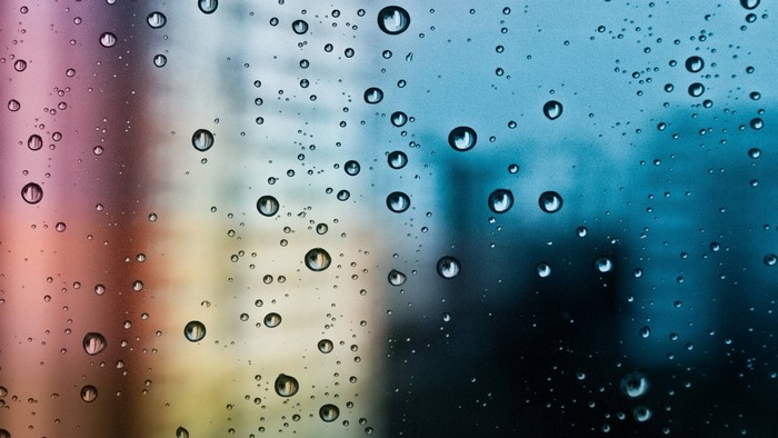 Water drops on a colorful glass surface
